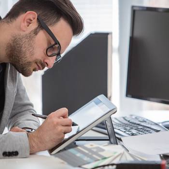 99 per cent of our products are green man working on a tablet with a stylus