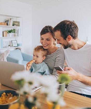 Compensation and benefits family at home in front of a laptop
