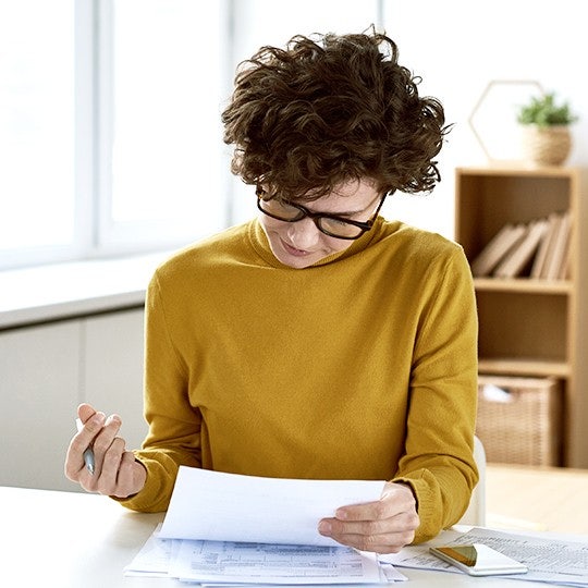 woman looking into some papers