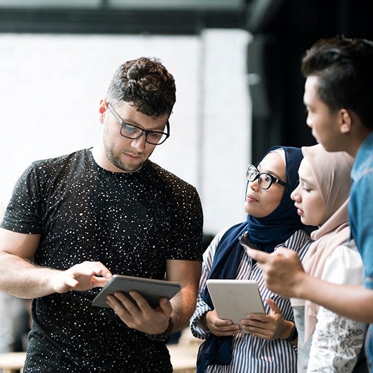 people looking into a tablet