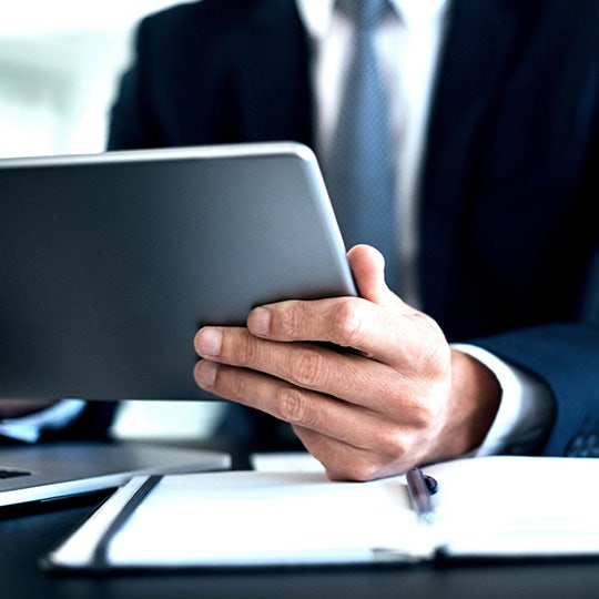 close up of businessman using tablet