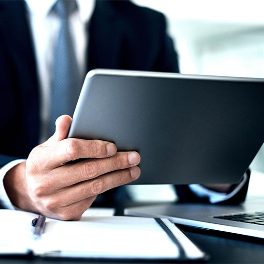 man looking into his tablet