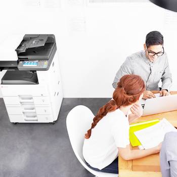 birds eye view of colleagues in a meeting next to kyocera printer