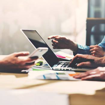 close up of two people working on a computer