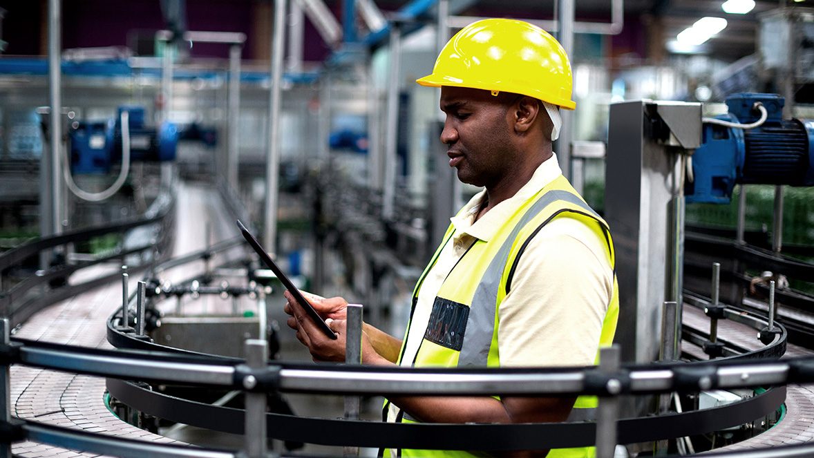 workman in hard hat working on a tablet workman in hard hat working on a tablet