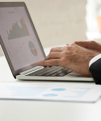 Ganho close up of hands typing on a laptop keyboard