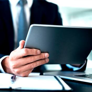 Identifying cybersecurity threats man typing in his tablet